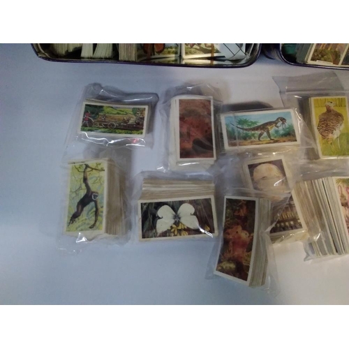 207 - THREE TINS OF ASSORTED TEA AND CIGARETTE CARDS, LOOSE AND IN SLOTS