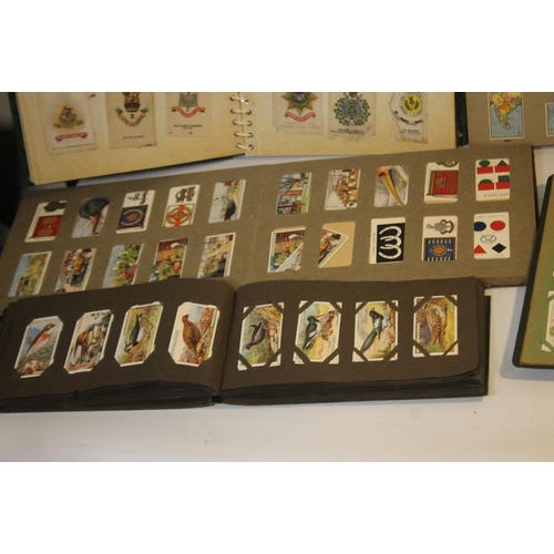 214 - A COLLECTION OF CIGARETTE CARDS IN VARIOUS ALBUMS, to include a small quantity of silks of British m... 