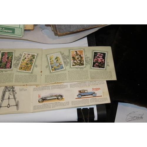 218 - A LARGE QUANTITY OF CIGARETTE CARDS LOOSE AND IN ALBUMS, to include areophane's, garden flowers, his... 