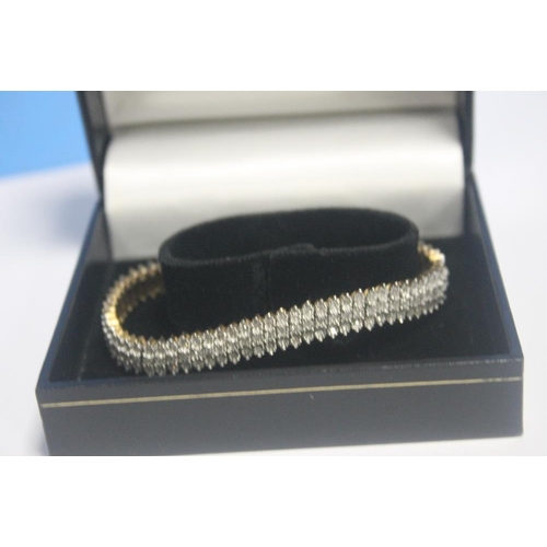 151 - A 9CT GOLD AND SYNTHETIC BRACELET