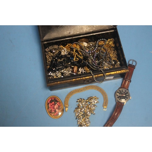 161 - A TIN OF ASSORTED COSTUME JEWELLERY AND A WRIST WATCH