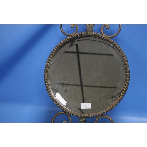 18 - A SMALL CIRCLED BEVEL EDGED MIRROR IN METAL GILT FRAME