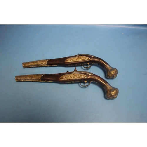 185 - A NEAR PAIR OF EASTERN FLINTLOCK PISTOLS