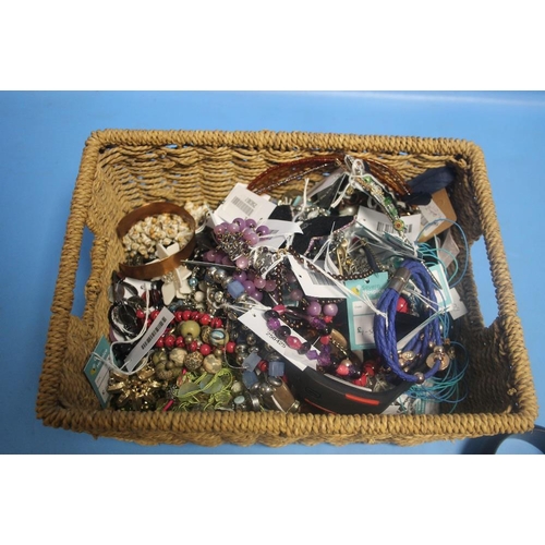 192 - A WICKER BASKET OF COSTUME JEWELLERY