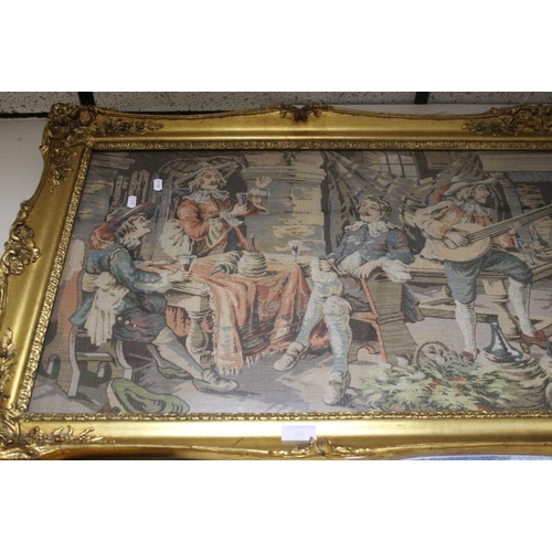 24 - A LARGE GILT FRAMED TAPESTRY OF AN 18TH CENTURY TAVERN SCENE 60.5 CM X 160.5 CM