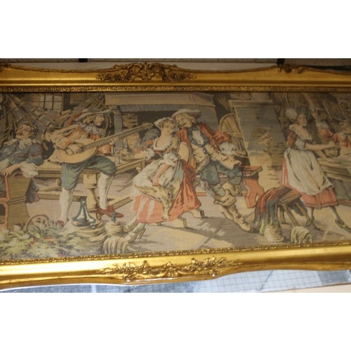 24 - A LARGE GILT FRAMED TAPESTRY OF AN 18TH CENTURY TAVERN SCENE 60.5 CM X 160.5 CM