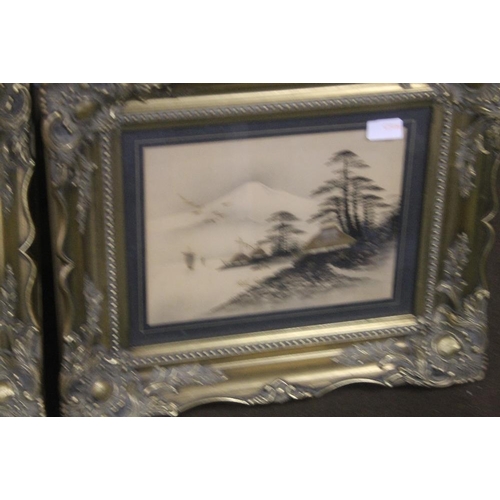 12 - A PAIR OF JAPANESE PICTURES HIGHLIGHTED IN GOLD IN ORNATE GILT FRAMES