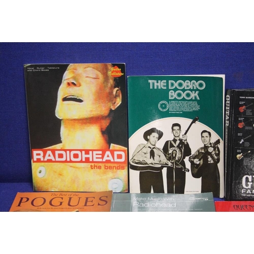 150 - A COLLECTION OF MUSIC RELATED BOOKS TO INCLUDE THE POGUES, BOB DYLAN , BOWIE, RADIO HEAD ETC