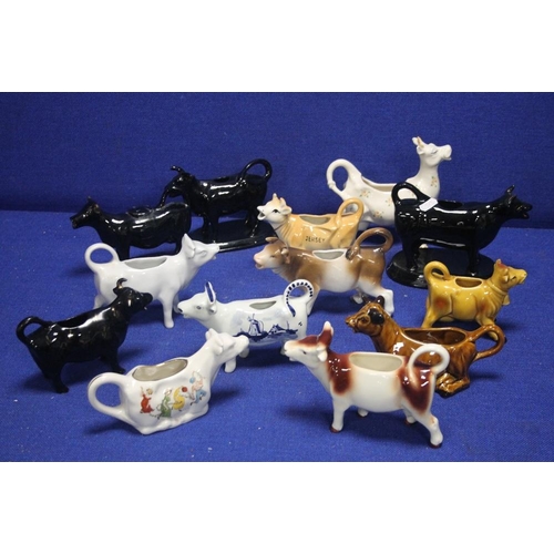 154 - A COLLECTION OF CERAMIC JUGS IN THE FORM OF COWS TO INCLUDE BESWICK