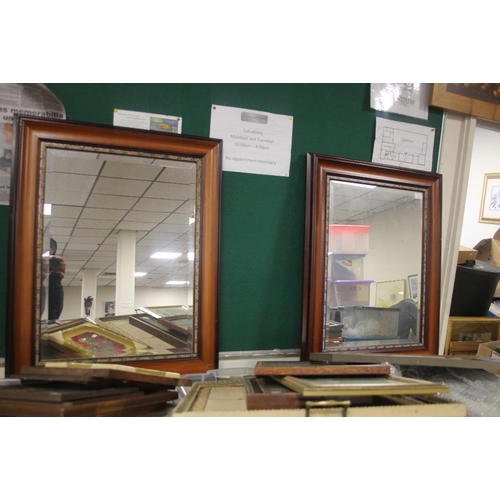 17 - A PAIR OF FRAMED MIRRORS 107 CM X 63 CM