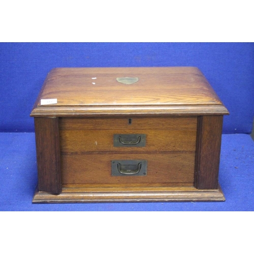 371 - AN OAK CASED TWO DRAWER CABINET