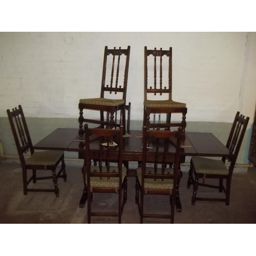 827 - A DARK OAK EXTENDING DINING SET TABLE WITH 8 CHAIRS