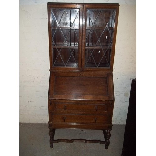 845 - AN OAK BUREAU BOOKCASE WITH KEY