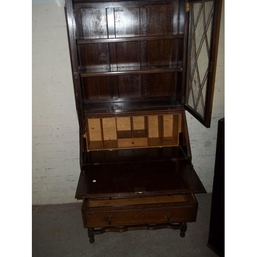 845 - AN OAK BUREAU BOOKCASE WITH KEY