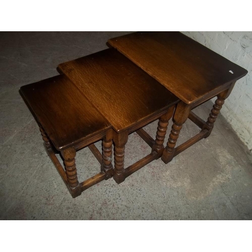 847 - AN ANTIQUE SOLID OAK NEST OF TABLES IN THE STYLE OF TITCHMARSH AND GOODWIN