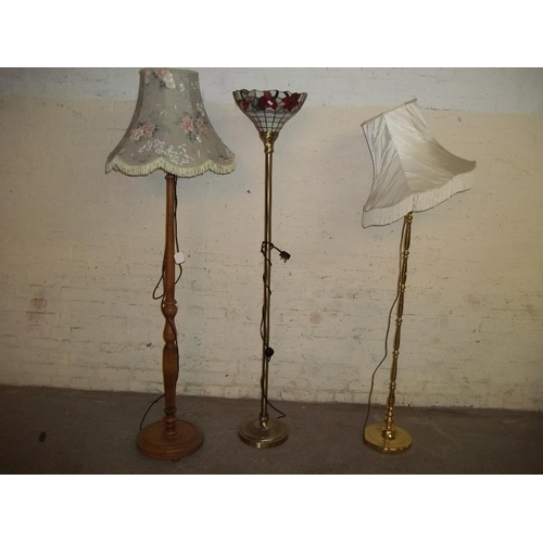 853 - THREE FLOOR STANDING STANDARD LAMPS INCLUDING TIFFANY STYLE ONE AND A BRASS ONE