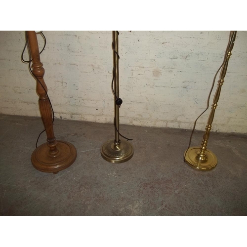 853 - THREE FLOOR STANDING STANDARD LAMPS INCLUDING TIFFANY STYLE ONE AND A BRASS ONE