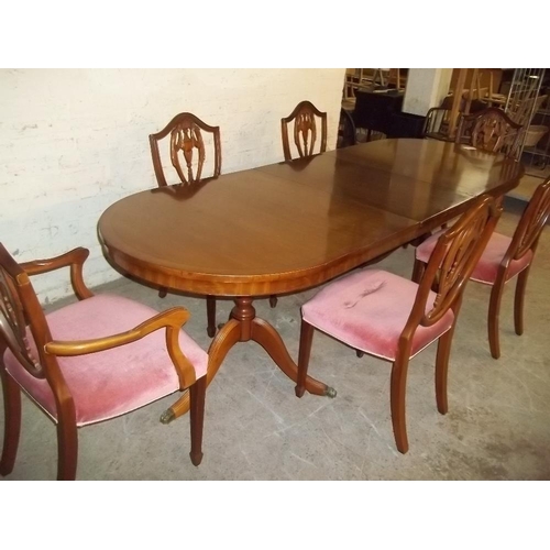 860 - AN EXTENDING DINING TABLE AND 6 CHAIRS