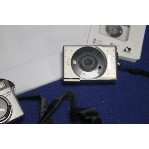 144 - A MINOLTA DIGITAL CAMERA WITH INSTRUCTION MANUAL ALONG WITH A SMALL CANON CAMERA