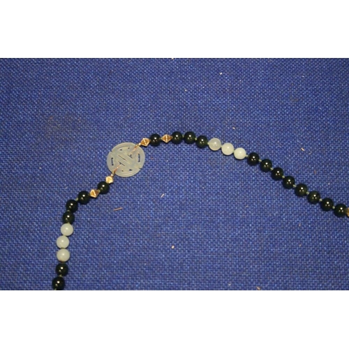 85 - A CHINESE JADE TYPE BEAD NECKLACE WITH 2 CHARACTER PANELS