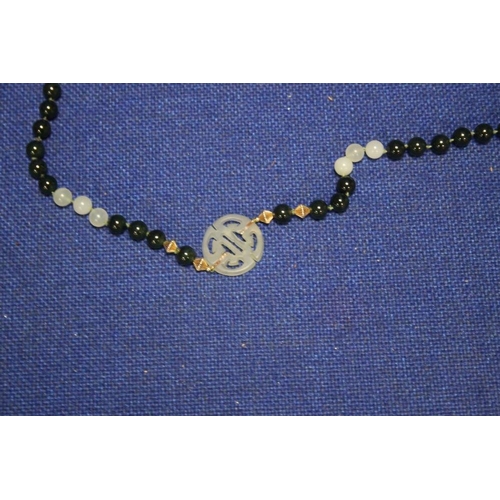 85 - A CHINESE JADE TYPE BEAD NECKLACE WITH 2 CHARACTER PANELS