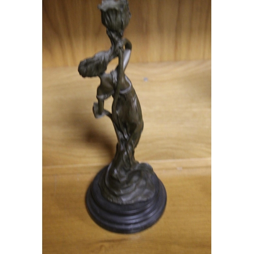 125 - A BRONZE TYPE FIGURE OF A CANDLE STICK