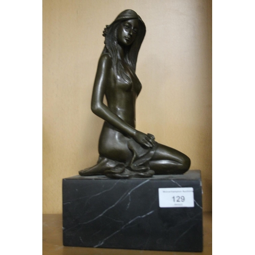 129 - A BRONZE TYPE FIGURE OF A LADY