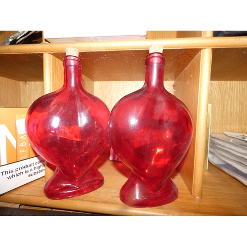 12 - PAIR OF RED GLASS DECANTERS