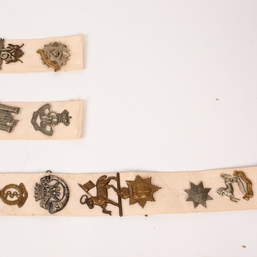 12 - 38 British Cap Badges, mounted on cloth strips

*All badges etc. are sold as seen