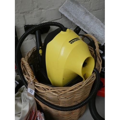 32 - A Karcher pressure washer in a wicker basket