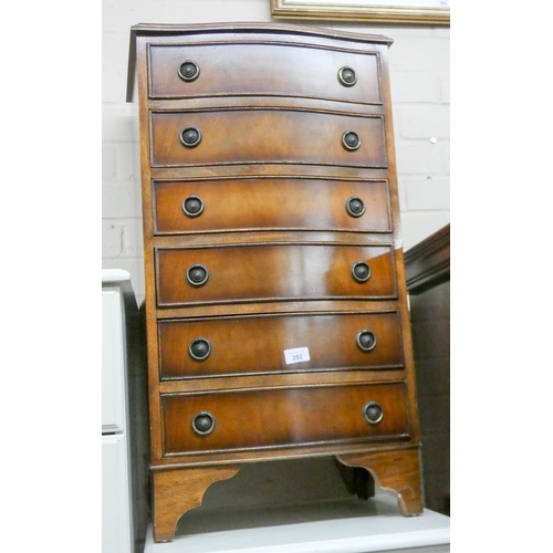 282 - A small reproduction mahogany serpentine front chest of six drawers