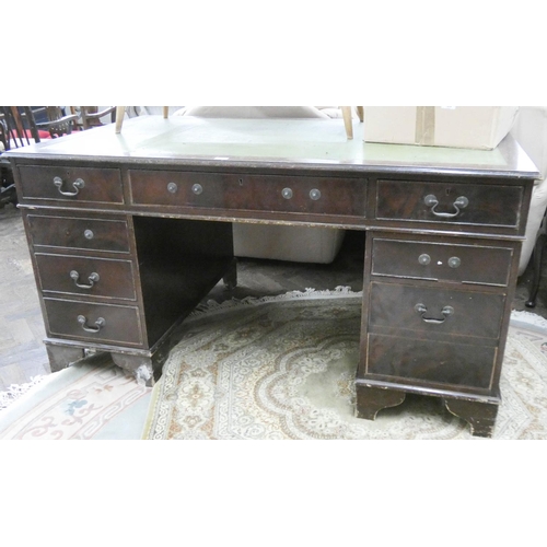 483 - A dark mahogany kneehole pedestal desk with green leather top, 5' x 3'