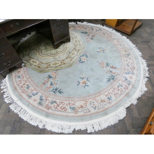 485 - A large pale green embossed circular Chinese rug and an octagonal patterned rug