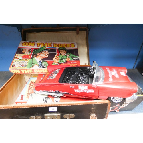 61 - A suitcase containing old 60-70's games, a large convertible model car and a box of single vinyl rec... 