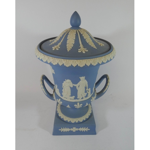 500 - A Wedgwood Jasper twin handled urn and cover standing on a square base, 30cms tall