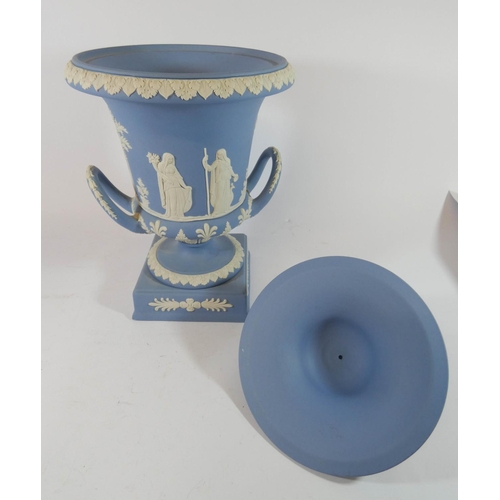 500 - A Wedgwood Jasper twin handled urn and cover standing on a square base, 30cms tall