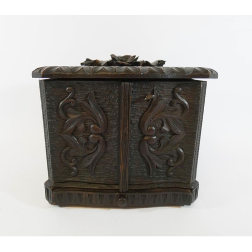 546 - An early 20th century carved Black Forest humidor table casket with lifting lid and fold out compart... 