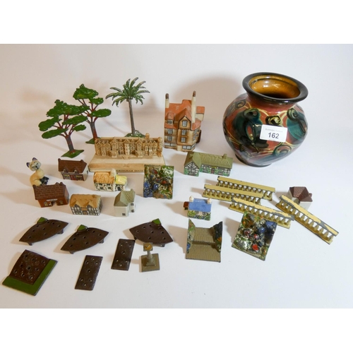 85 - Assorted miniature houses and an Art pottery vase