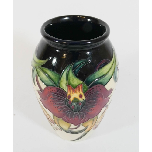 497 - A modern Moorcroft Anna lilly decorated vase, 14cms tall