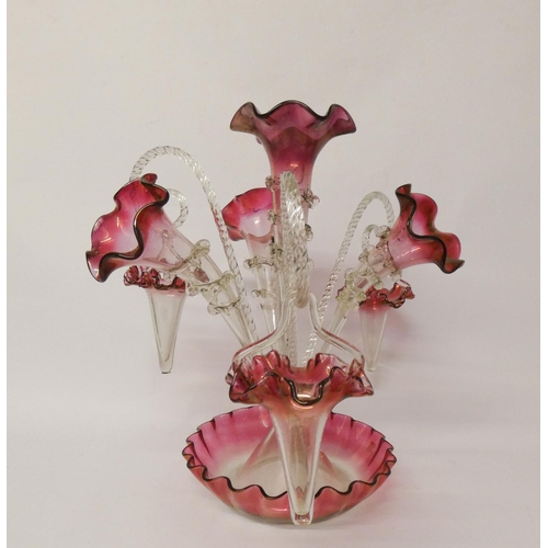 574 - A frilled clear and cranberry tinged glass epergne, with trumpets and baskets, 42 cms tall