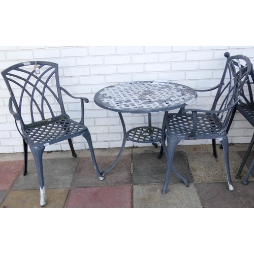 114 - A small circular painted metal garden table with two matching chair, matching previous lot