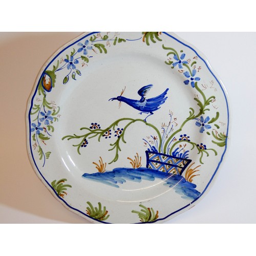 575 - A French pottery La Rochelle wall plate decorated with an exotic bird, signed on reverse, 24cms acro... 