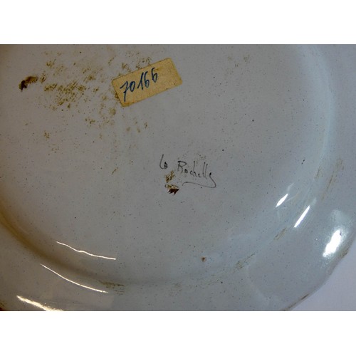 575 - A French pottery La Rochelle wall plate decorated with an exotic bird, signed on reverse, 24cms acro... 