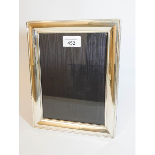 452 - A rectangular modern silver easel photograph frame, 25cms tall