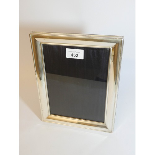 452 - A rectangular modern silver easel photograph frame, 25cms tall