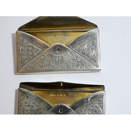 455 - Two very similar hallmark silver envelope card cases with engraved decoration, each measuring 8cms a... 