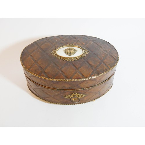 461 - An antique oval leather and mother of pearl inlaid gilt metal mounted jewellery casket measuring 18c... 