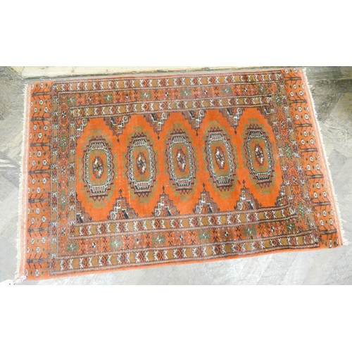 293 - A red patterned Bokhara design wool pile rug, approximately 4' x 2'6