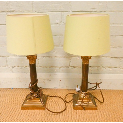 804 - A pair of brass Corinthian column table lamps with green shades