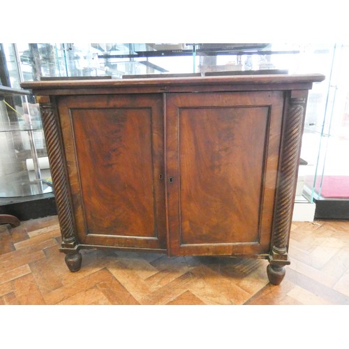 802 - A 19th century framed mahogany two door cabinet with turned pilasters to the sides